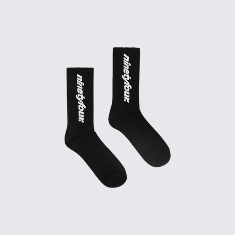 The Ninetyfour DEBUT SOCKS in BLACK, a perfect blend of comfort and style. Crafted from high-quality materials, these socks feature our distinctive white Fundamentals logo.