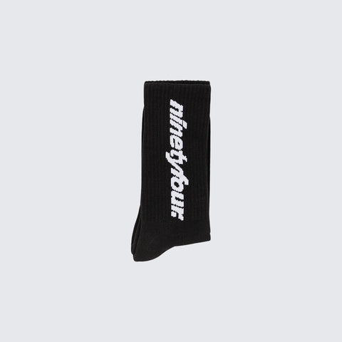 The Ninetyfour DEBUT SOCKS in BLACK, a perfect blend of comfort and style. Crafted from high-quality materials, these socks feature our distinctive white Fundamentals logo.